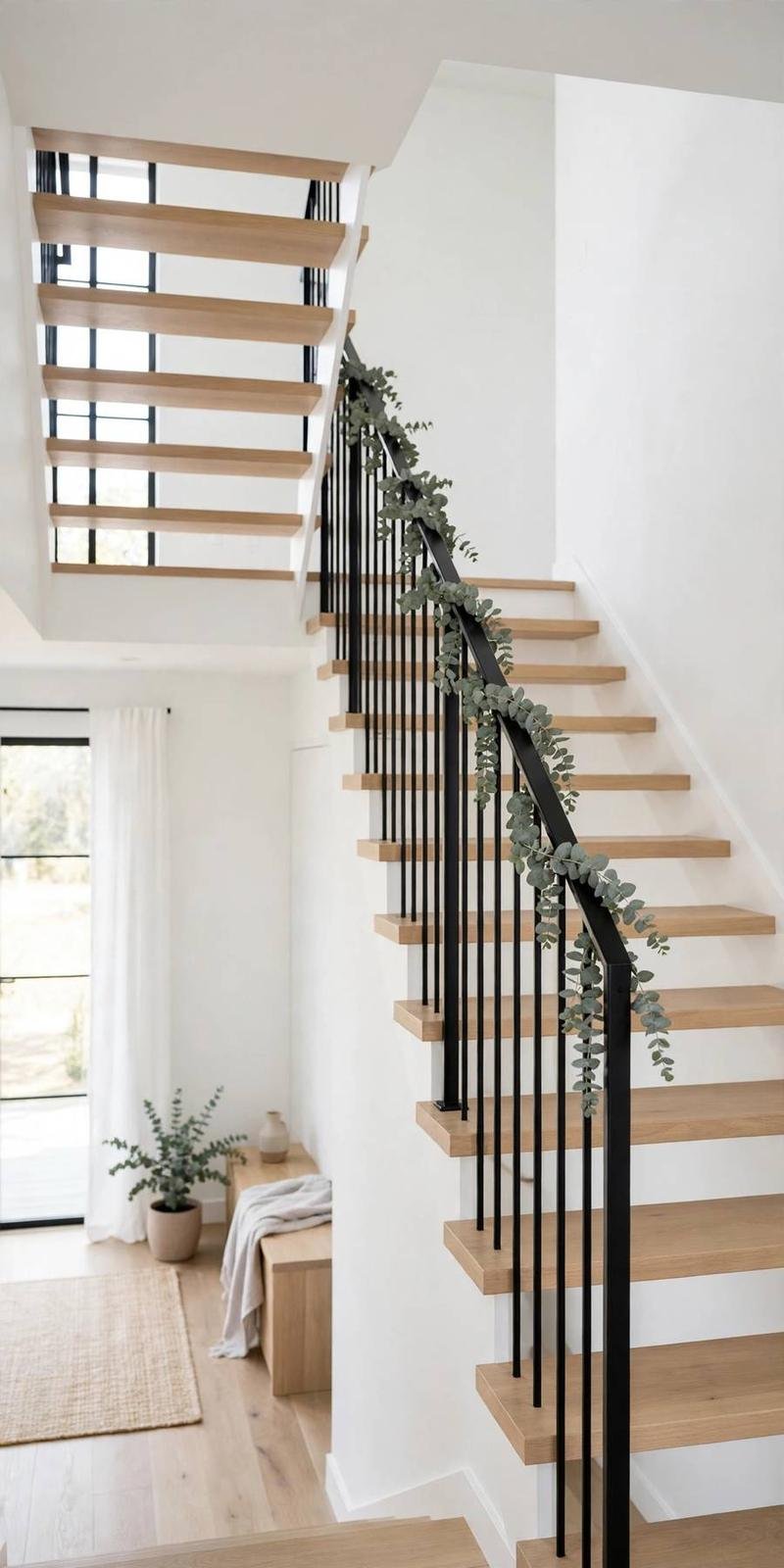 garland staircase: minimalist eucalyptus garland on a modern black stair railing