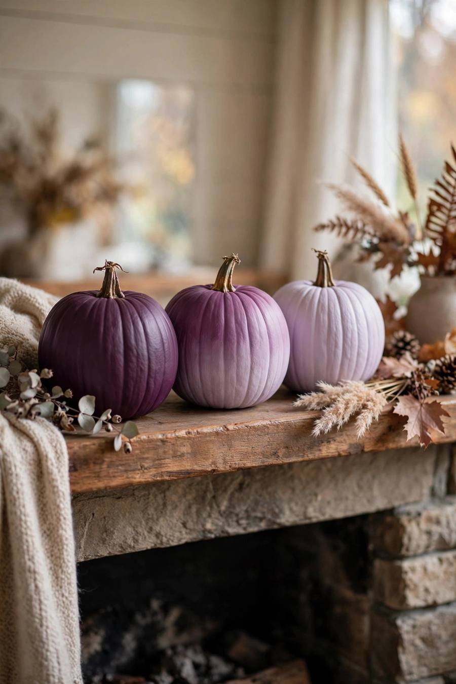 Pumpkin painting ideas: ombre gradient pumpkins from plum to lavender on a mantel