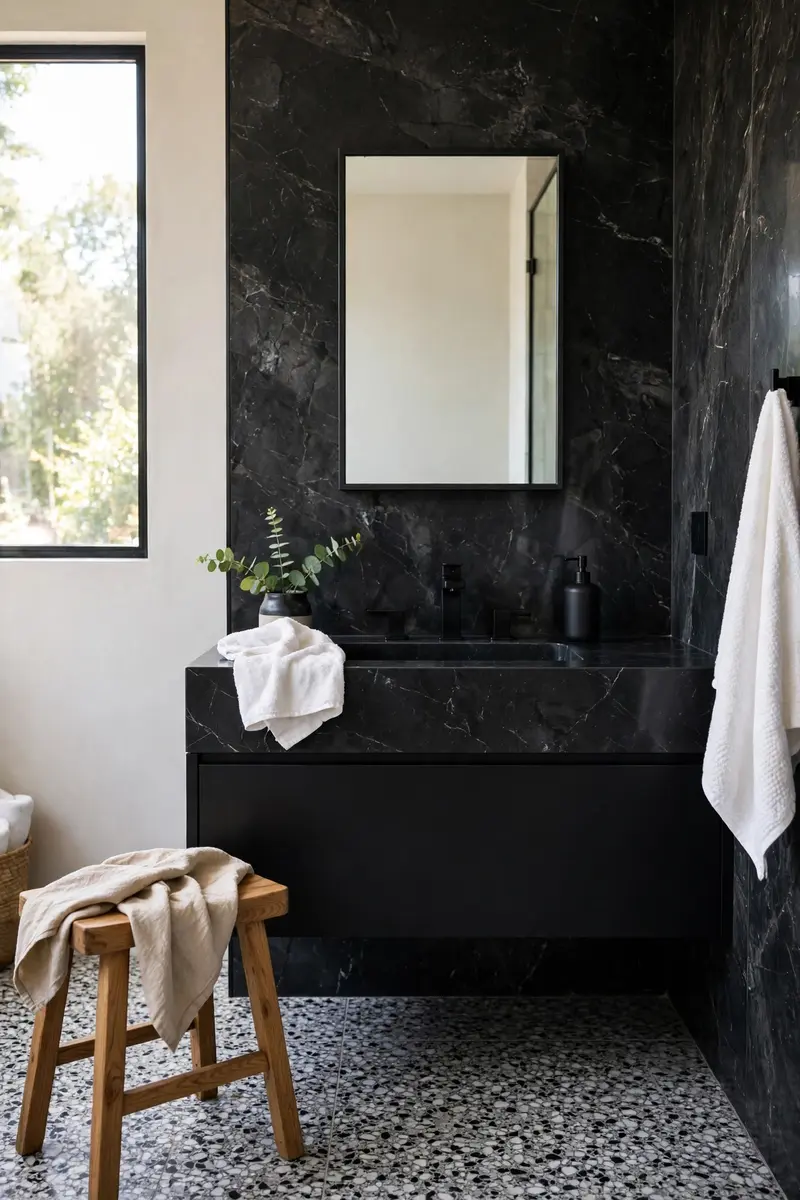 Terrazzo floor tiles with black marble vanity wall